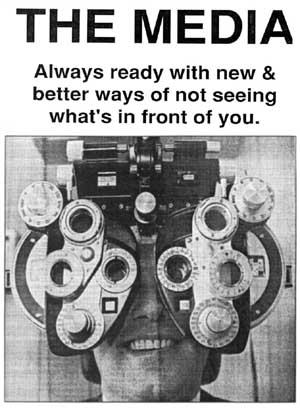 photo of a man grinning, with his eyes covered by a mass of optometric equipment.  The caption above says - 'The Media - always ready with new and better ways of not seeing what's in front of you'.