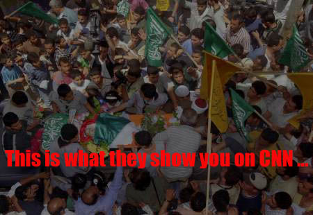 Photo of a large crowd of Palestinian people at the funeral of a murdered Palestinian baby. Looking down from above you see the people surrounding the baby's corpse as it is carried on some kind of platform, surrounded with flowers, with only his pale little face showing. In red letters the caption on the photo says - 'This is what they show you on CNN...'