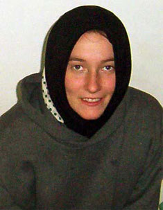 photo of  a beautiful young White woman, Rachel Corrie, smiling as she looks intently at the viewer.