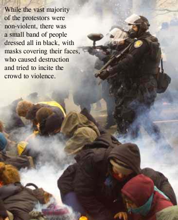 photo of several black-clad, helmeted, masked pigs with shotguns standing in clouds of tear gas which they have fired - one is pointing his shotgun horizontally to fire another tear gas round, another is pointing his shotgun down toward people who are sitting huddled together on the street in the midst of thick swirling white tear gas all around them.  Text on the photograph reads - 'While the vast majority of the protestors were non-violent, there was a small band of people dressed all in black, with masks covering their faces, who caused destruction and tried to incite the crowd to violence'.